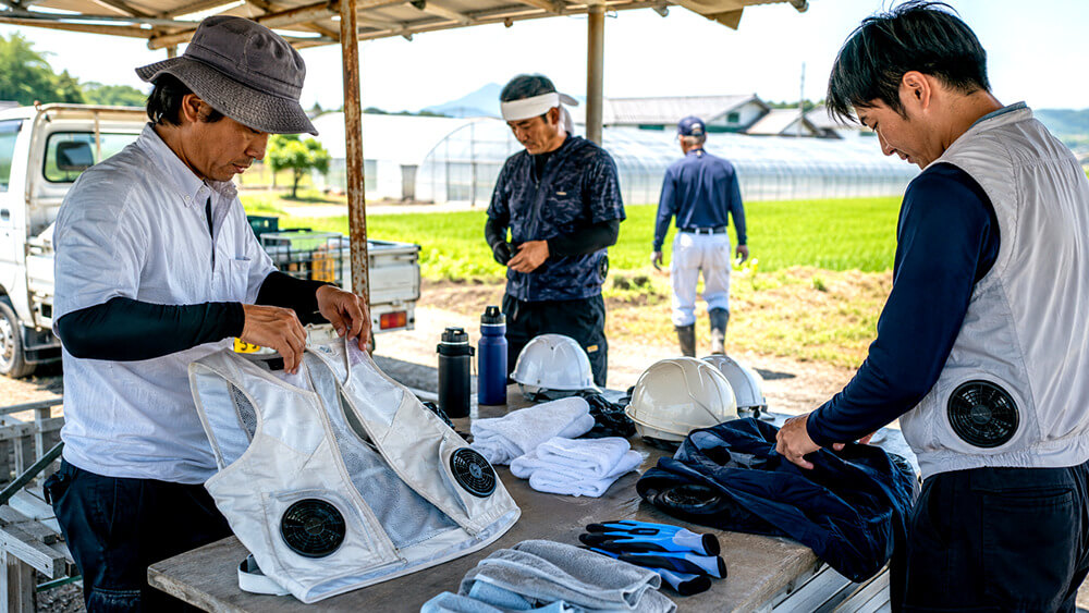 農作業で冷却ベストと空調服インナーを準備する作業者